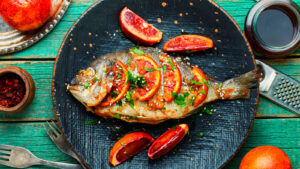 Grilled,Spicy,Dorado,Fish,With,Grapefruit.roasted,Fish,On,Old,Wooden
